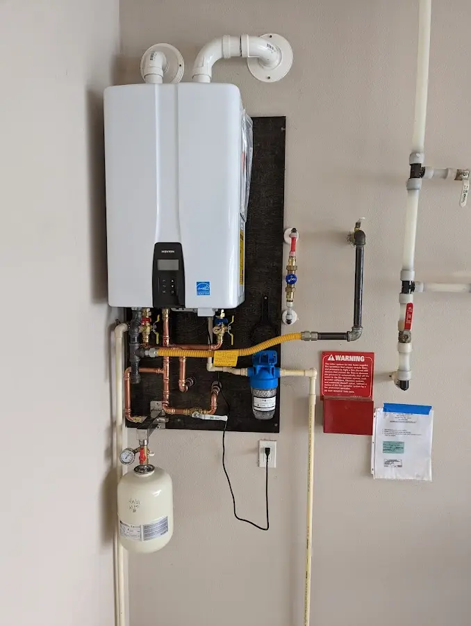 Professional plumber installing copper piping in a Mulvane home
